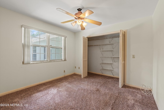 unfurnished bedroom featuring ceiling fan, a closet, and carpet