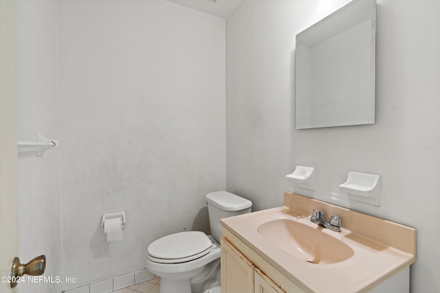 bathroom with vanity, tile patterned flooring, and toilet