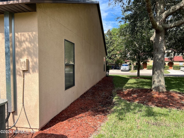 view of side of home with a yard