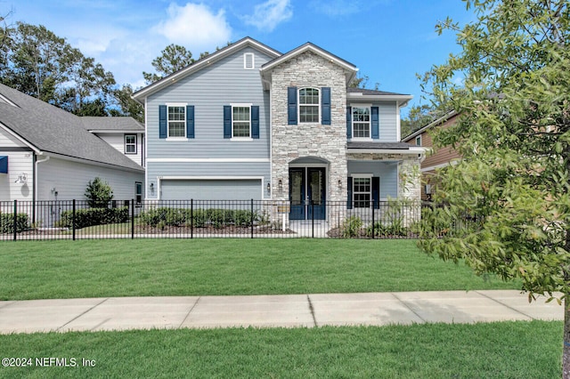 view of front facade with a front yard and a garage