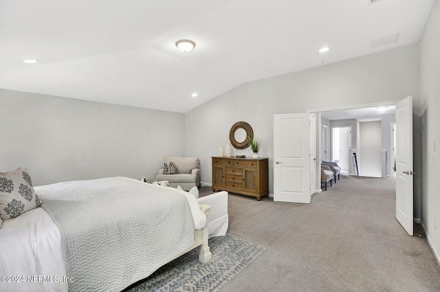 bedroom featuring vaulted ceiling and light colored carpet