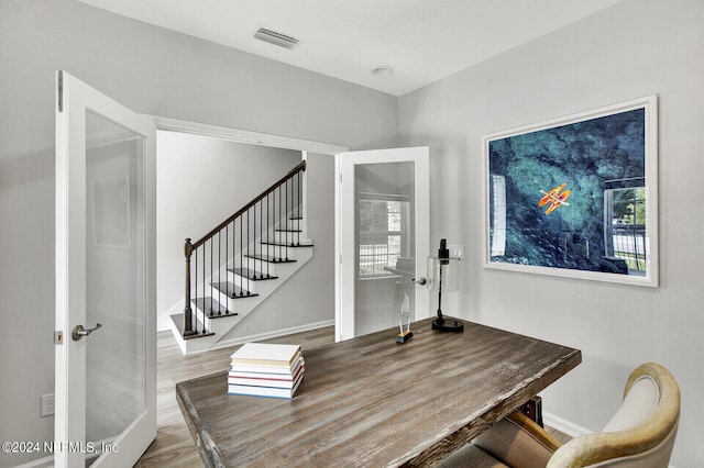 dining room featuring french doors and hardwood / wood-style flooring