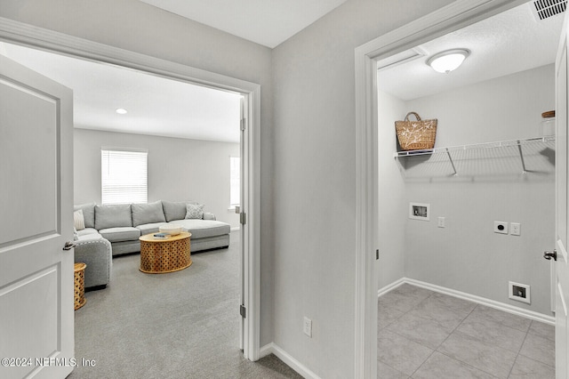 laundry area featuring hookup for a washing machine, electric dryer hookup, and light colored carpet