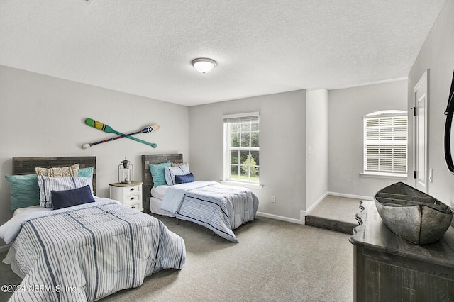 carpeted bedroom featuring a textured ceiling