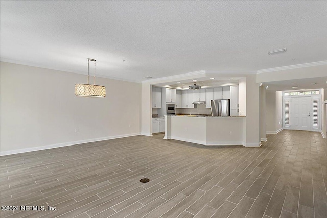 unfurnished living room with light hardwood / wood-style floors, a textured ceiling, and ornamental molding