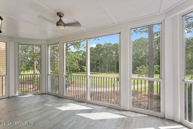 unfurnished sunroom featuring a wealth of natural light and ceiling fan