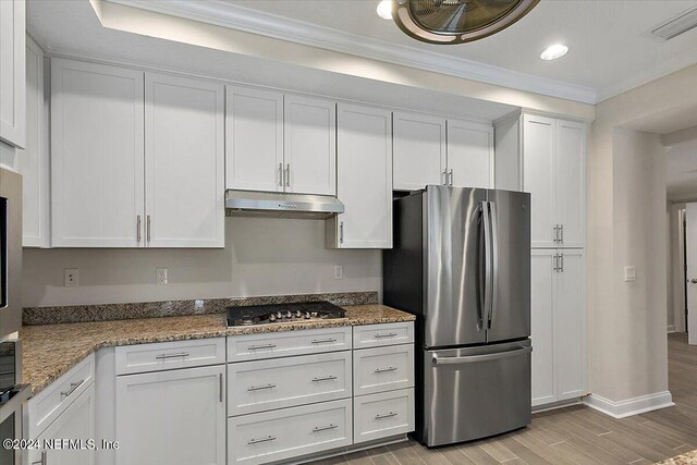 kitchen featuring white cabinets, stone countertops, light wood-type flooring, and appliances with stainless steel finishes