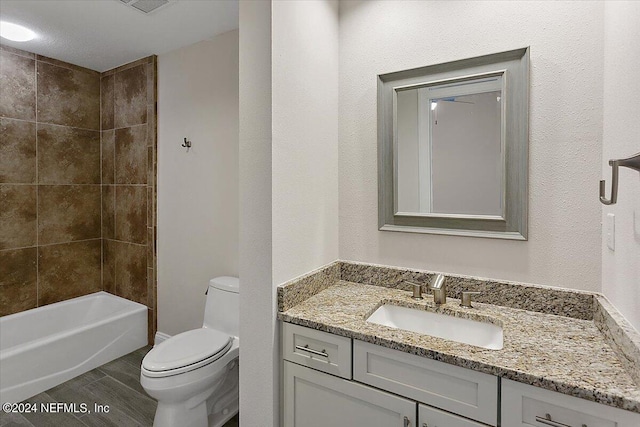 full bathroom with vanity, toilet, and tiled shower / bath