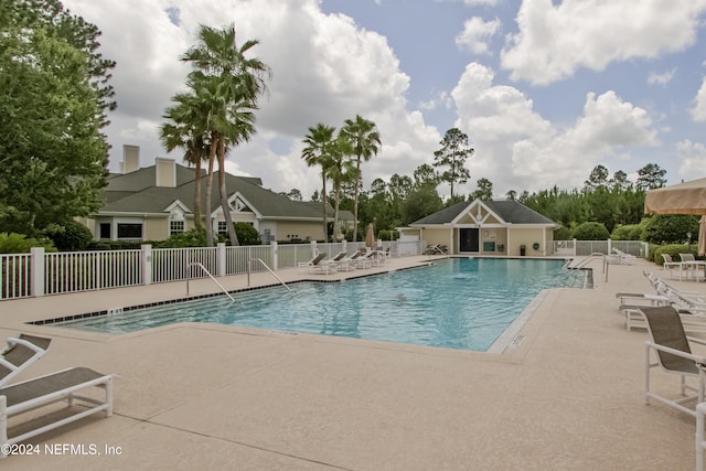 community pool featuring a patio and fence
