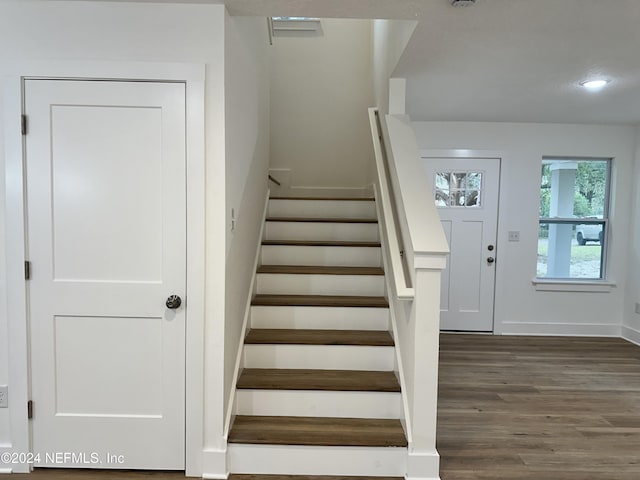 stairway featuring wood-type flooring