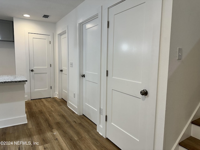 corridor with dark hardwood / wood-style flooring