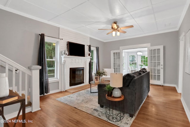 living room featuring hardwood / wood-style flooring, a fireplace, and plenty of natural light