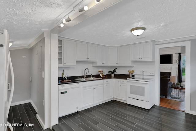 kitchen with dark hardwood / wood-style floors, white appliances, white cabinetry, and sink