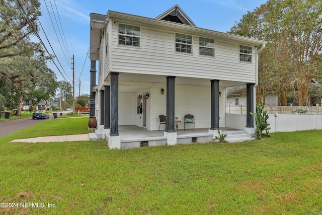 view of front of home featuring a front yard and covered porch