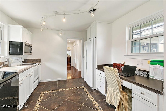 kitchen with built in desk, white appliances, white cabinetry, and dark hardwood / wood-style floors