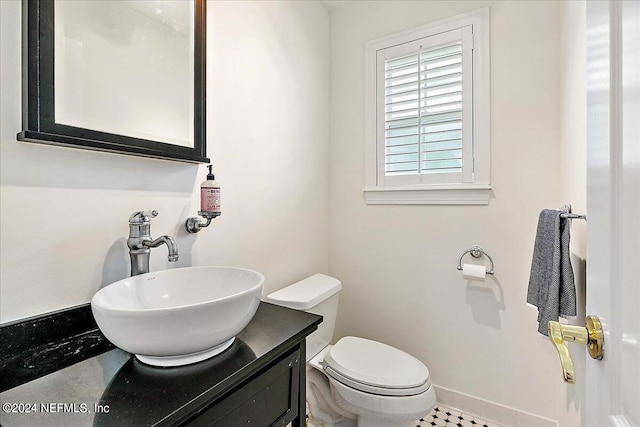 bathroom with vanity, tile patterned flooring, and toilet