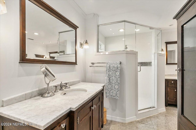 bathroom featuring crown molding, vanity, and an enclosed shower