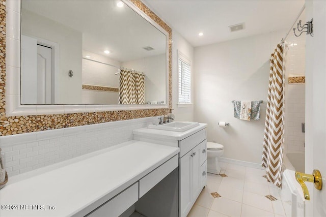 full bathroom featuring tile patterned flooring, vanity, toilet, and shower / bath combo with shower curtain