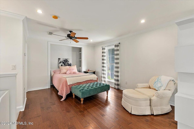 bedroom with crown molding, dark hardwood / wood-style flooring, and ceiling fan