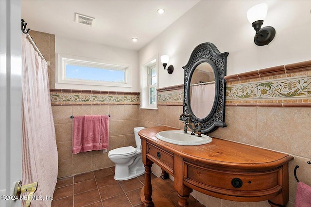 bathroom with vanity, tile walls, toilet, and tile patterned floors