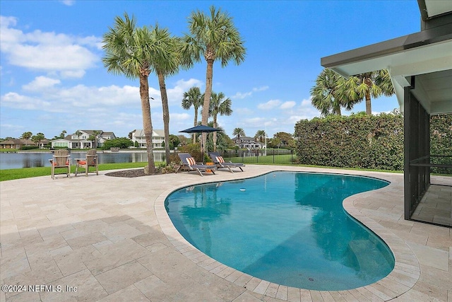 view of pool with a water view and a patio area