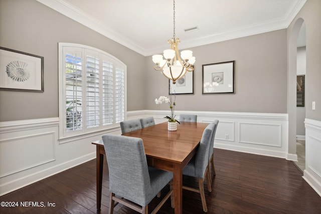 dining area with crown molding, a notable chandelier, and dark wood-type flooring