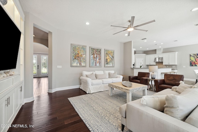 living room with french doors, ceiling fan, and dark hardwood / wood-style flooring