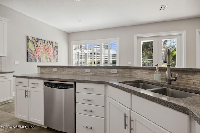 kitchen with decorative backsplash, white cabinetry, stainless steel dishwasher, french doors, and sink