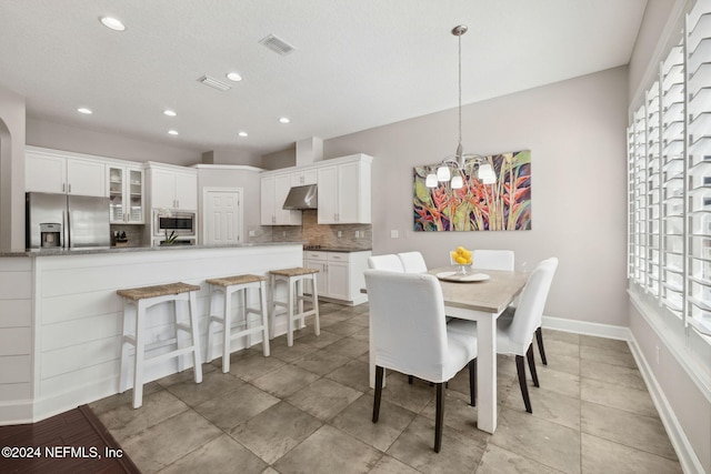 dining area with a notable chandelier and a healthy amount of sunlight