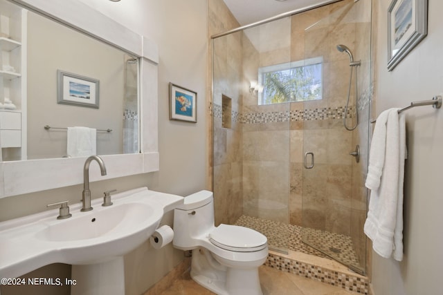 bathroom featuring toilet, tile patterned flooring, and a shower with door