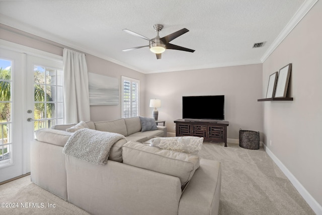 living room featuring a textured ceiling, light colored carpet, and a wealth of natural light