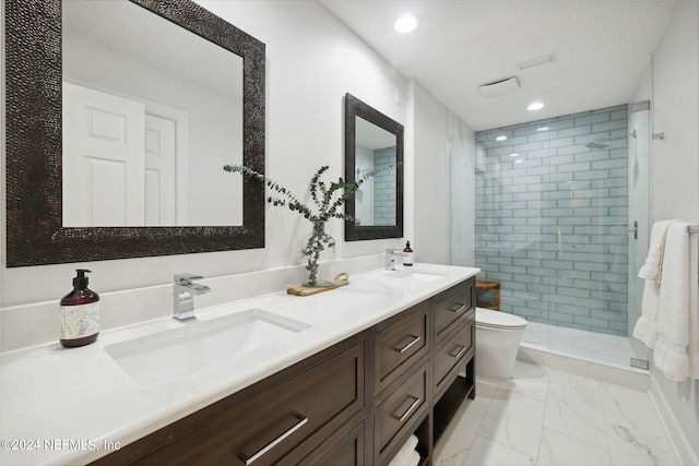 bathroom with vanity, a shower with shower door, and toilet