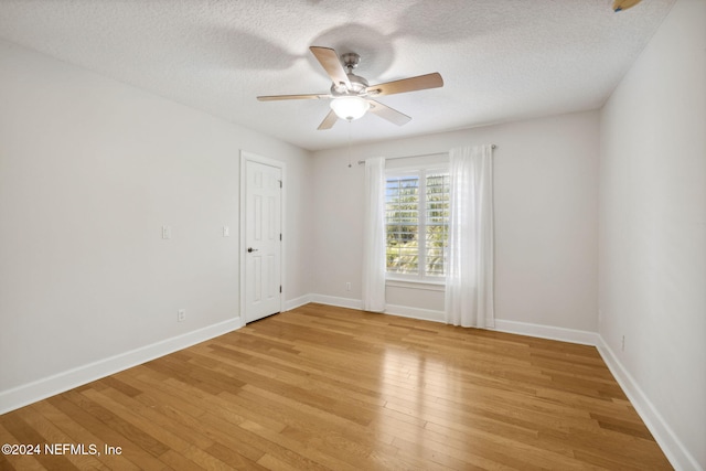 spare room featuring light hardwood / wood-style flooring, a textured ceiling, and ceiling fan