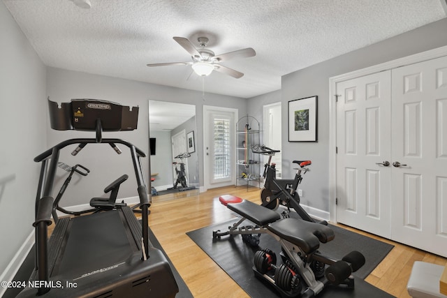 workout area featuring hardwood / wood-style floors, a textured ceiling, and ceiling fan