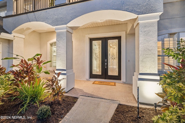 view of exterior entry featuring a balcony