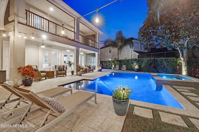 view of pool with a patio, an in ground hot tub, french doors, and outdoor lounge area