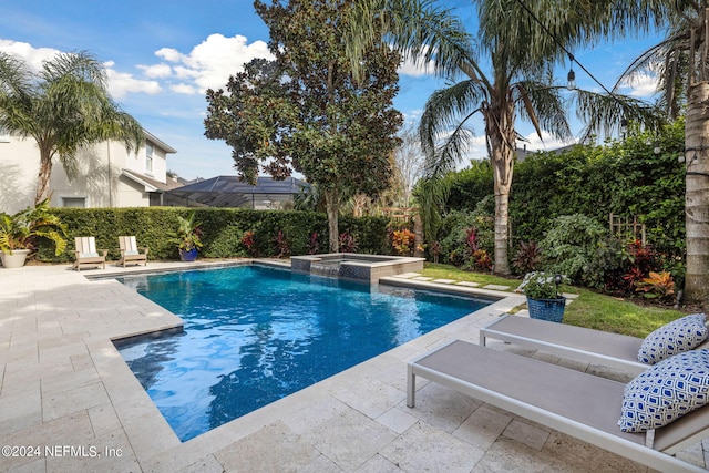 view of swimming pool featuring an in ground hot tub, a patio, and a lanai