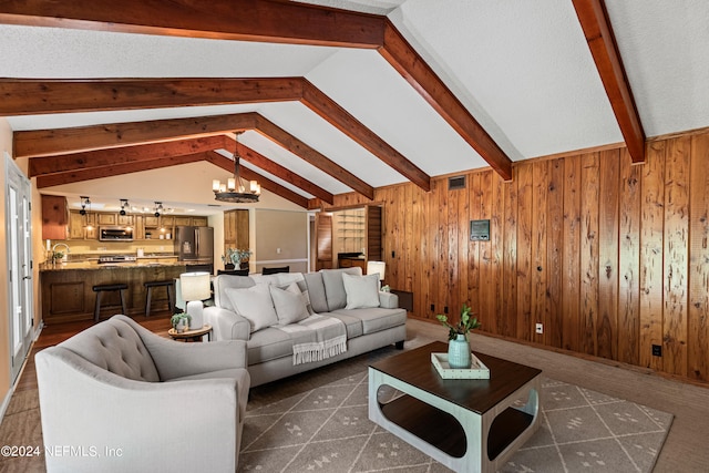 living room featuring vaulted ceiling with beams, wood walls, sink, and a chandelier