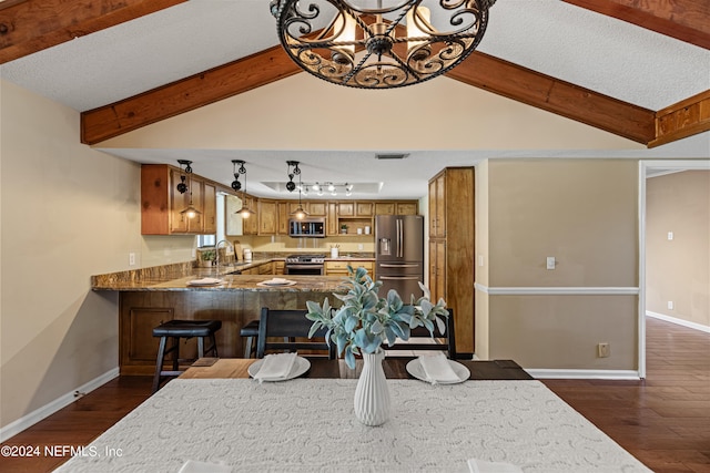 dining area featuring sink, lofted ceiling with beams, dark hardwood / wood-style floors, and a chandelier