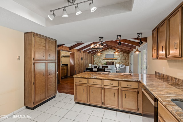 kitchen with a textured ceiling, kitchen peninsula, hanging light fixtures, vaulted ceiling with beams, and stainless steel dishwasher