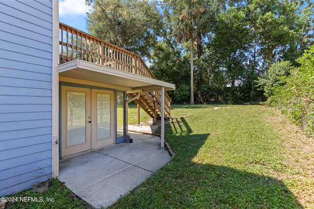 view of yard featuring a wooden deck and a patio