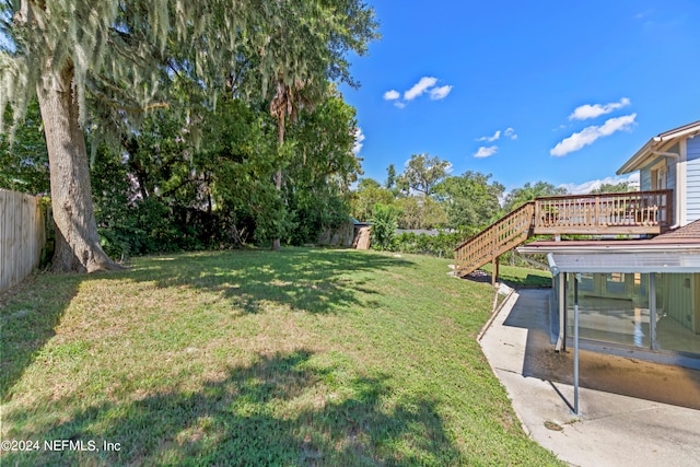 view of yard with a wooden deck and a patio area