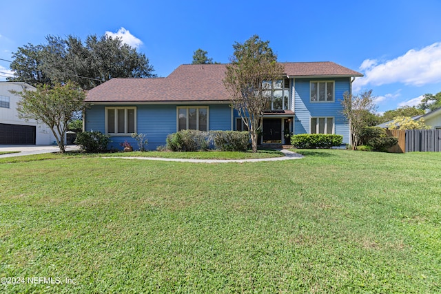 view of front of house with a front lawn and a garage