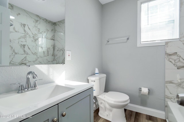 full bathroom featuring hardwood / wood-style floors, independent shower and bath, vanity, and toilet