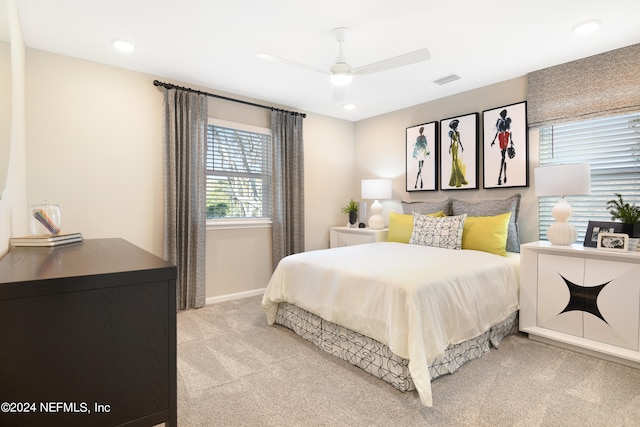 bedroom featuring ceiling fan and light carpet