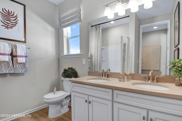 bathroom with vanity, hardwood / wood-style floors, and toilet