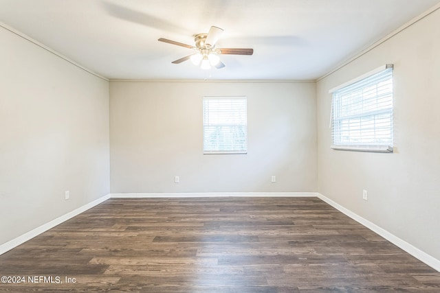 unfurnished room with ornamental molding, ceiling fan, and dark wood-type flooring