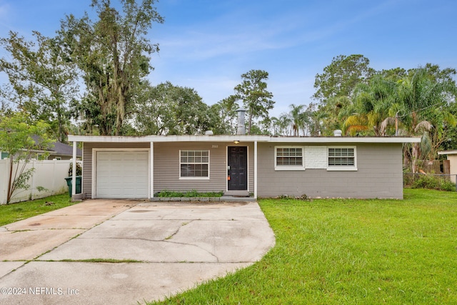 ranch-style house with a front yard and a garage