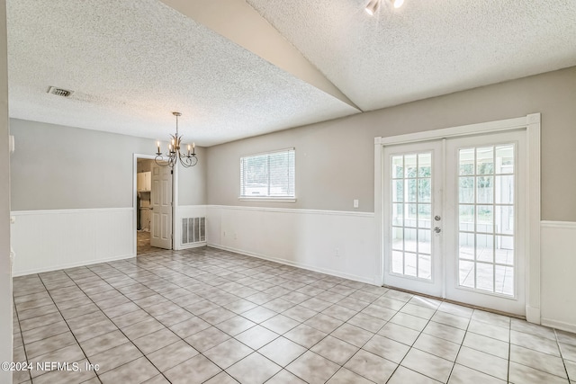 unfurnished dining area featuring a textured ceiling and plenty of natural light