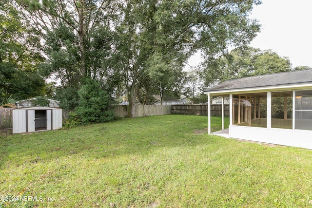 view of yard with a sunroom and a shed